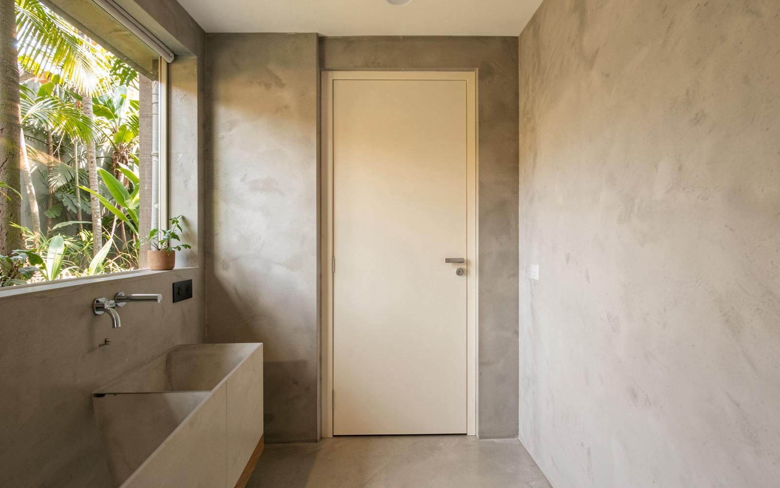 Baño con una puerta interior de WPC en acabado claro